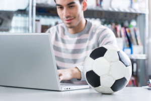 Man with football on desk